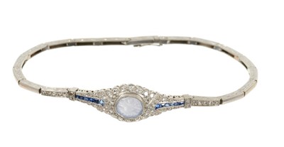 Lot 507 - Edwardian style diamond and sapphire bracelet with a carved cabochon blue sapphire surrounded by single cut diamonds and flanked by calibre cut sapphires on an articulated and engraved white gold b...