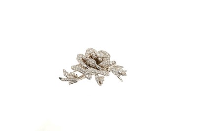 Lot 421 - Diamond floral spray brooch in the form of a rose with a central diamond cluster surrounded by pavé set diamond petals and a rosebud and foliage set with baguette cut and brilliant cut diamonds in...