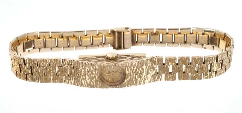 Lot 612 - Ladies' Bueche-Girod 9ct gold wristwatch on integral gold bark-effect bracelet