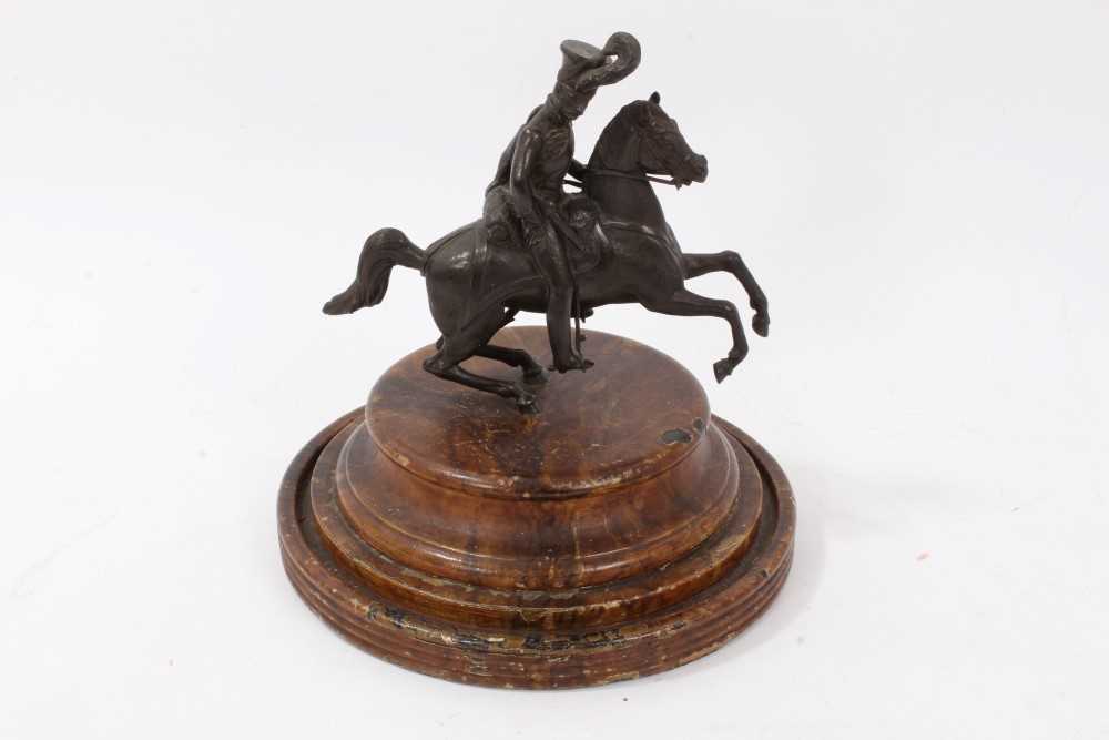 Lot 32 - A 19th century bronze figure of a Hussar on horseback, on turned wooden base