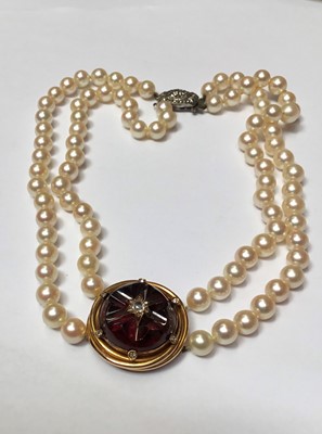 Lot 161 - Cultured pearl two strand necklace with a Victorian carved garnet and old cut diamond cluster