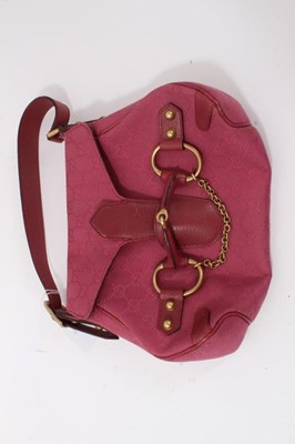 Lot 1794 - Gucci horse-bit handbag in magenta pink monogram fabric.