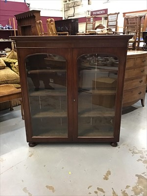 Lot 899 - Victorian mahogany bookcase with two glazed doors on bun feet