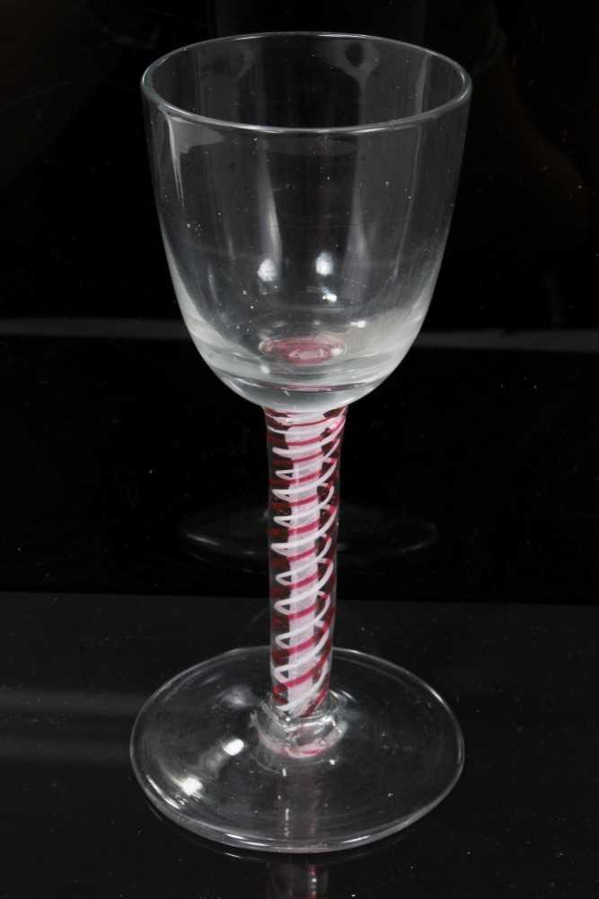 Lot 163 - 18th century Dutch wine glass with funnel bowl, on white gauze and red and white twist stem on plain foot, circa 1770, 14cm