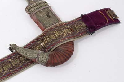 Lot 37 - Mid-20th century Arab Jambia dagger with horn hilt and white metal and brown mounts, with sheath and original woven belt