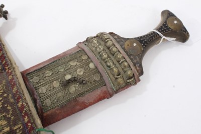 Lot 37 - Mid-20th century Arab Jambia dagger with horn hilt and white metal and brown mounts, with sheath and original woven belt