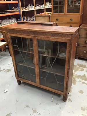 Lot 960 - Carved oak bookcase enclosed by two astragal leaded glazed doors