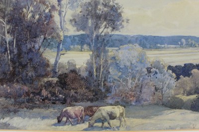 Lot 944 - George Robert Rushton (1869-1947) three watercolours - cattle grazing in extensive landscape, 35cm x 50cm, hilly landscape, 27cm x 38cm and low tide on the estuary, 27cm x 37cm, each in glazed fram...