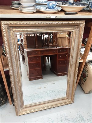 Lot 933 - Bevelled wall mirror in ornate gilt frame