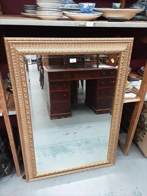 Lot 934 - Bevelled mirror in ornate gilt frame