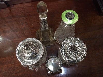 Lot 675 - Silver collared glass perfume bottle, enamel topped silver glass perfume bottle and three others