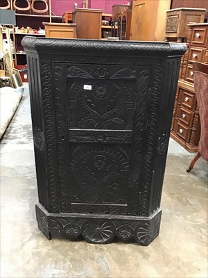 Lot 987 - Antique heavily carved oak corner cupboard with shelved interior enclosed by carved panelled door