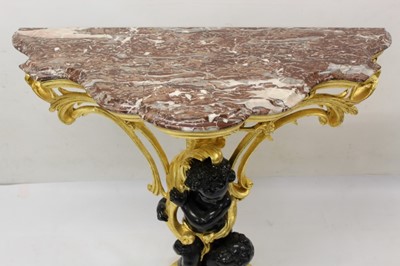 Lot 1226 - Decorative gilt and ebonised pier table with shaped rouge marble top supported by two blackamoors with foliate scrolling ornament, 100cm wide