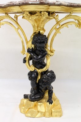 Lot 1226 - Decorative gilt and ebonised pier table with shaped rouge marble top supported by two blackamoors with foliate scrolling ornament, 100cm wide