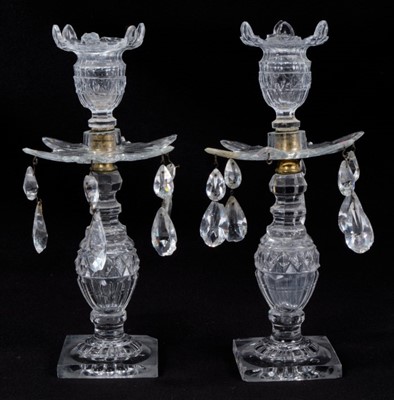 Lot 142 - Pair of Regency period cut glass lustre candlesticks, the drip pans hanging with faceted drop shapes lustres, 25.5cm height