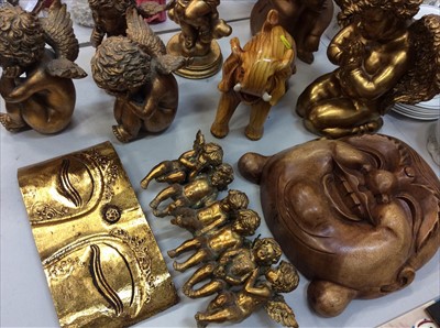 Lot 461 - Gilt Cupid ornaments, large wooden Buddha mask and a wooden elephant ornament