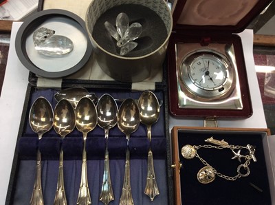 Lot 711 - Silver charm bracelet, R. Carr silver mounted bedside clock and set of plated teaspoons in case