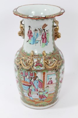 Lot 184 - Late 19th century Chinese famille rose baluster vase, painted in the Canton style with figural scenes, flowers and birds, with moulded foo dog handles and dragons, 33.5cm height