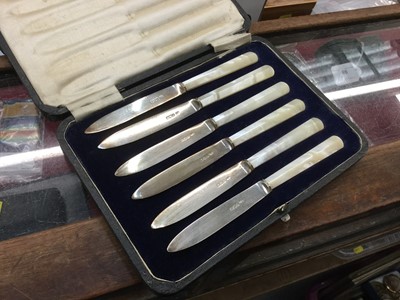 Lot 718 - Six silver other of pearl handled tea knives in fitted case