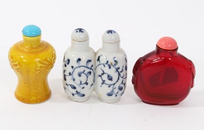 Lot 717 - Chinese Peking glass snuff bottle, together with two Chinese porcelain snuff bottles.