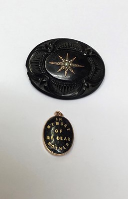 Lot 153 - Victorian gold and black enamel mourning locket 'In Memory Of My Dear Mother', together with a Victorian carved jet brooch with seed pearl star motif