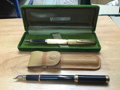Lot 310 - Waterman gold plated fountain pen with 18k gold nib , Waterman's ladies miniature black and gold plated fountain pen with 18k gold nib in brown leather case (2)