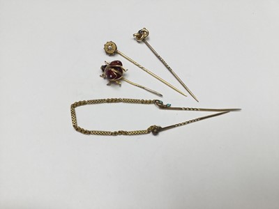Lot 278 - Group of four gold stick pins to include a novelty 9ct gold and enamel flying ladybird stickpin, and three Victorian gold stick pins