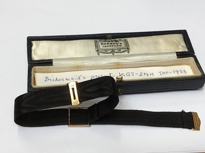 Lot 181 - 1920s black silk bracelet with 9ct gold enamel and seed pearl panel with gothic initial with gold clasp, in original Harrods box with note 'Bridesmaid's present KGS-ENH Dec.1925'
