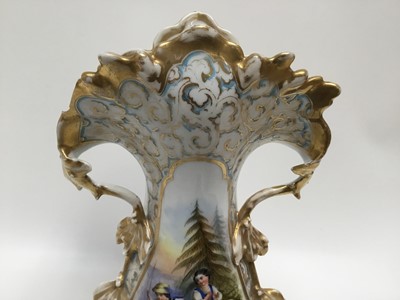 Lot 285 - Late 19th century Continental porcelain vase of shaped form with central hand painted scene depicting two figures beside the river, with gilded foliate borders, 39cm high