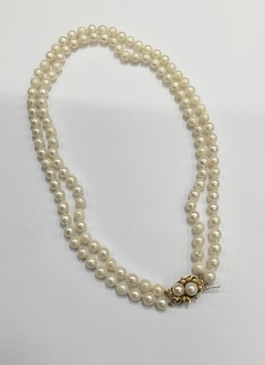 Lot 199 - Cultured pearl two strand necklace with two strings of 7mm diameter cultured pearls on a gold clasp, approximately 48cm/19" length