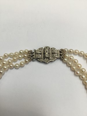 Lot 200 - Cultured pearl three strand choker necklace with three strings of graduated cultured pearls measuring approximately 2.3mm- 7.4mm, on an Art Deco style 9ct white gold and diamond set clasp. Length a...