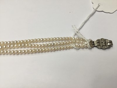 Lot 200 - Cultured pearl three strand choker necklace with three strings of graduated cultured pearls measuring approximately 2.3mm- 7.4mm, on an Art Deco style 9ct white gold and diamond set clasp. Length a...