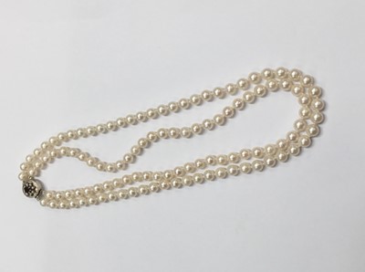Lot 201 - Cultured pearl two strand necklace with two strings of 6.5mm cultured pearls on a silver and garnet cluster clasp. Length approximately 42cm