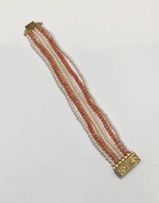 Lot 202 - Coral bead and cultured pearl six-strand bracelet with yellow metal clasp. 19cm