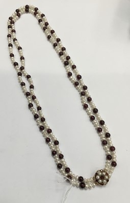 Lot 207 - Garnet and cultured pearl necklace with two strings of garnet beads interspaced by cultured freshwater pearls on a 9ct gold garnet and cultured pearl clasp, 56cm length