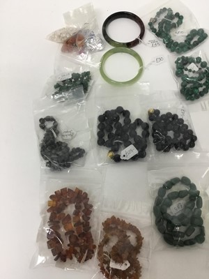Lot 219 - Group of necklaces to include malachite bead necklaces, amber necklaces, two greenstone bangles and others