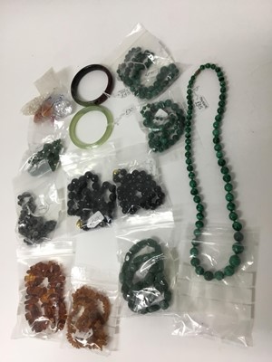 Lot 219 - Group of necklaces to include malachite bead necklaces, amber necklaces, two greenstone bangles and others