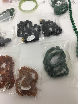 Lot 219 - Group of necklaces to include malachite bead necklaces, amber necklaces, two greenstone bangles and others