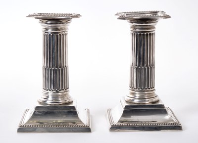 Lot 257 - Pair of Edwardian silver dwarf Corinthian column candlesticks