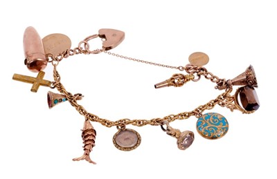 Lot 406 - Charm bracelet with twelve gold and gilt metal charms to include antique locket and seals