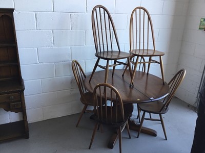 Lot 28 - Ercol 'Golden Dawn' extending dining table of circular form, together with six Ercol stick back dining chairs