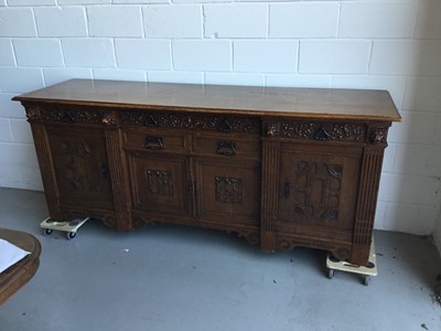 Lot 23 - Large and impressive early 20th Century carved oak sideboard, six draws with carved floral decoration, carved lion masks and four panelled doors below, rear stamped 'Schneider, Frankfurt', 235cm in...
