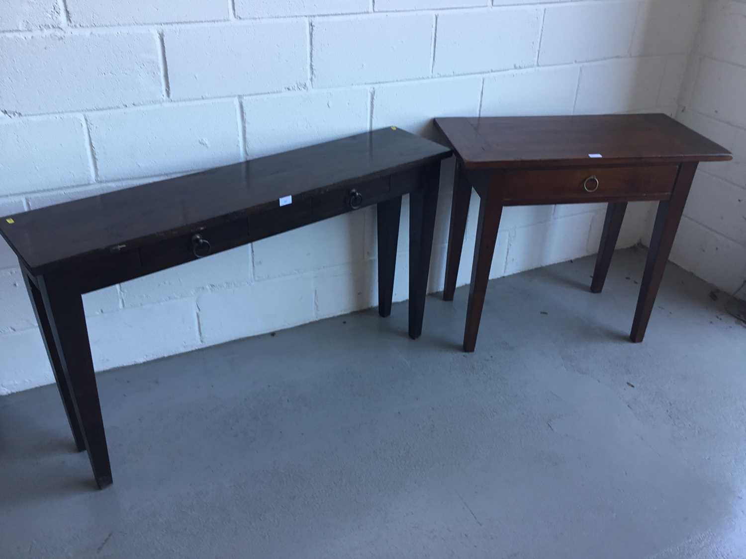 Lot 27 - Contemporary hardwood hall table of narrow form, with two draws on square taper legs, by Lombok, together with another similar smaller table. Larger table 130cm in length, 76cm in height, 30cm in d...