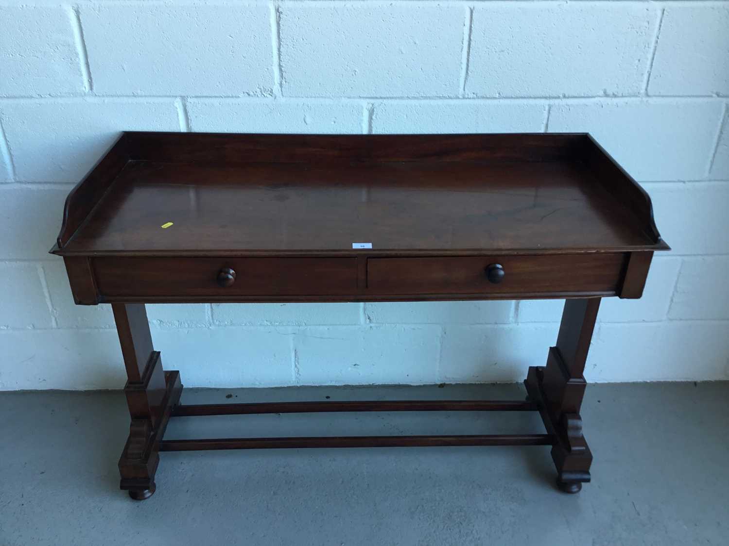 Lot 38 - Victorian mahogany hall table with raised ledge back and sides, end standards joined by two stretchers on bun feet, 122cm in length, 82cm in height, 49cm depth