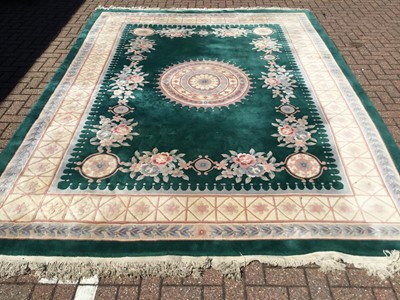 Lot 42 - Large Chinese wash rug with geometric and floral decoration on green ground, 366 x 270cm together with another rug Contemporary pale blue rug, measuring 241 x 175cm (2)