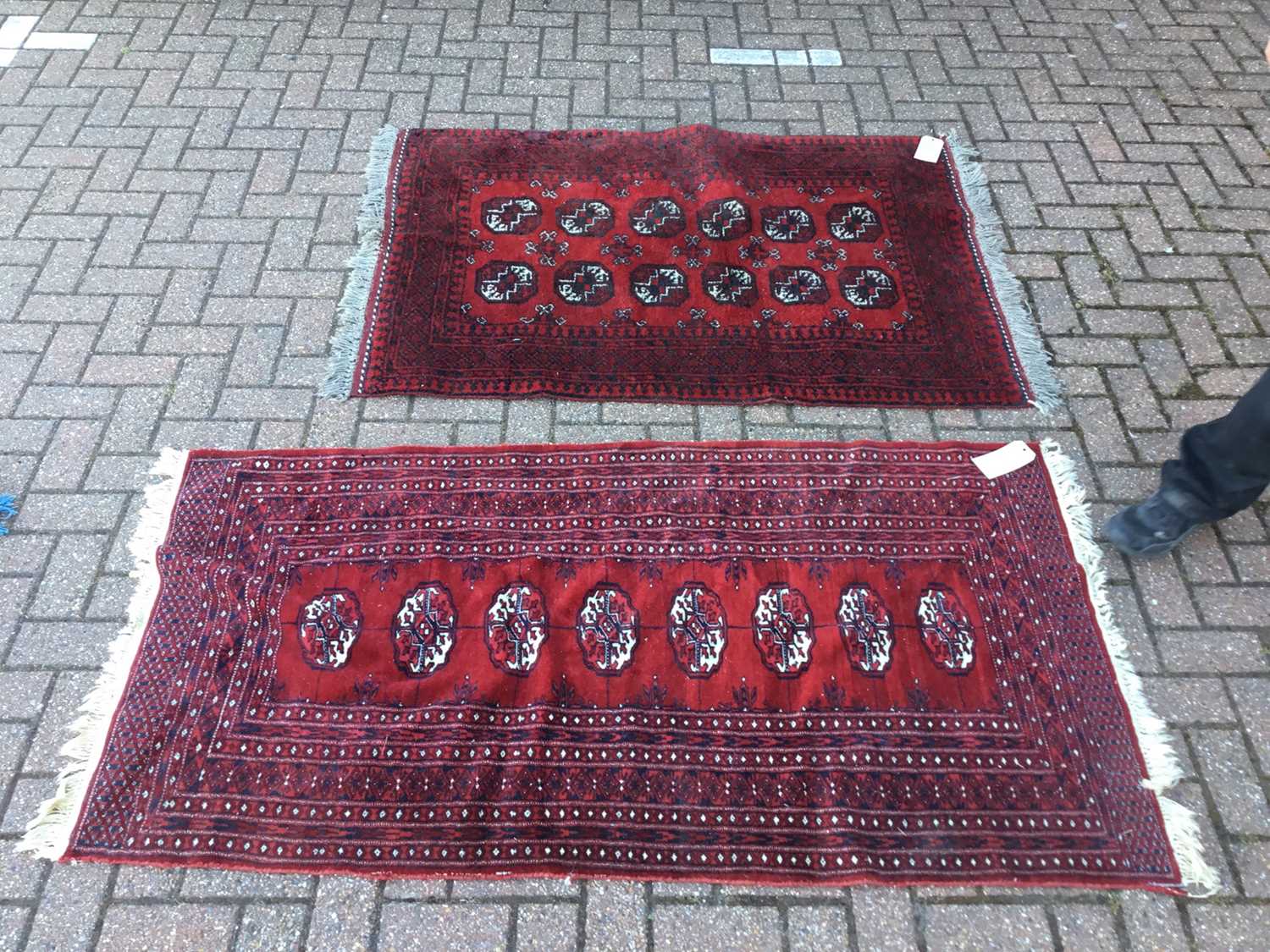 Lot 43 - Two Eastern Rugs with geometric decoration on red ground, 155 x 104cm and 178 x 91cm
