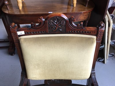Lot 54 - Edwardian carved wood armchair with green velvet upholstery and padded arms, on turned legs together with a matching easy chair (2)