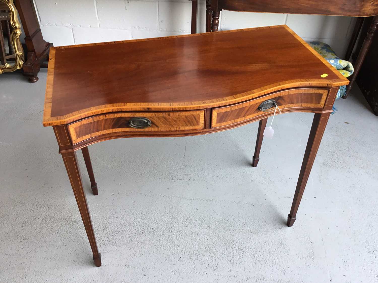 Lot 57 - Good Qualty reproduction mahogany serpentine fronted side table by Redman & Hales, with inlaid and crossbanded decoration ,and two drawers, on square taper legs, 89cm in length, 76cm in height, 45c...