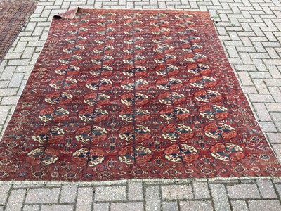 Lot 87 - Eastern rug with geometric decoration on red ground, 230 x 188cm together with another similar measuring 165 x 115cm and a third on cream ground measuring 185 x 143cm (3)