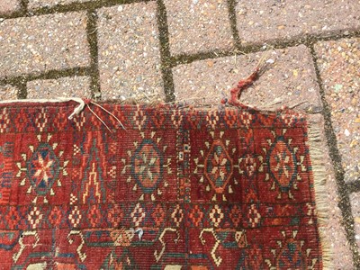 Lot 87 - Eastern rug with geometric decoration on red ground, 230 x 188cm together with another similar measuring 165 x 115cm and a third on cream ground measuring 185 x 143cm (3)